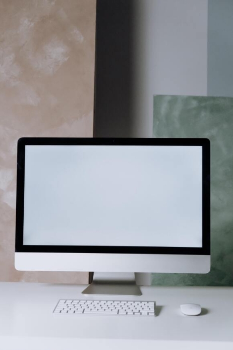 A desktop computer screen on the table Template | PosterMyWall