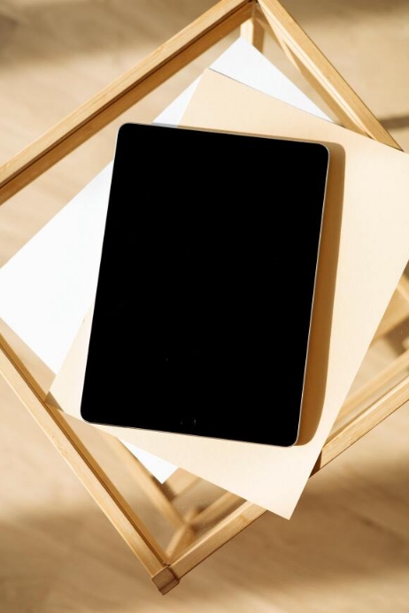 An ipad on top of a blank sheet Template | PosterMyWall