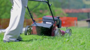 Man cutting grass with machine in the field Miniatura na YouTube template
